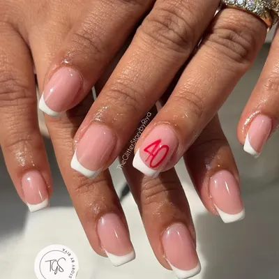 A classic French manicure with a personal touch. This client wanted to celebrate a milestone, so we added the number '40' in a clean, red script to the accent nail.