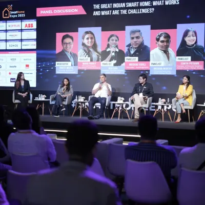 A wide shot of a panel discussion on "The Great Indian Smart Home," where experts debate the challenges and opportunities in the domestic market.