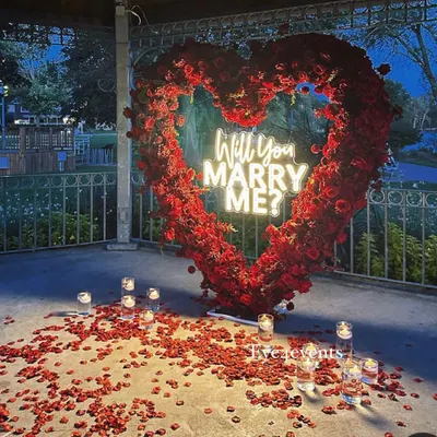 You can never go wrong with classic red roses. This magnificent heart-shaped arch, filled with hundreds of roses and a "Will You Marry Me?" neon sign, creates the ultimate romantic statement.