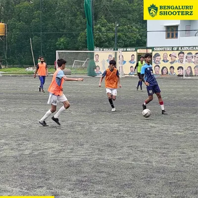 Our players in action during a competitive match, demonstrating ball control and spatial awareness. These game scenarios are crucial for developing tactical intelligence.