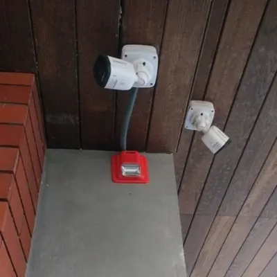 We provide comprehensive security, not just cameras. Here, our team has installed two CCTV cameras alongside a fire alarm system for integrated safety and surveillance.