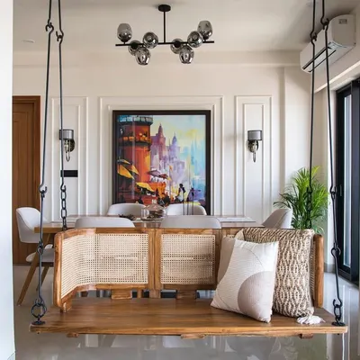 A classic feature in many homes I design is a traditional Indian swing, or 'jhoola'. Here, it’s integrated into a modern living space, offering a playful and relaxing spot with a view of the dining area.