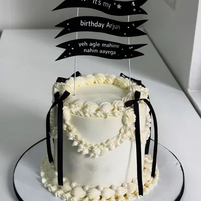 This cake understands the assignment. A Korean-style vintage design with clean piping, classic black and white drama, and a topper that adds a touch of relatable birthday humor.