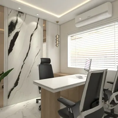 This executive cabin for a CA office in Bhiwandi showcases our 'less is more' philosophy. We used a book-matched marble feature wall and vertical panels with bronze strips to create a sense of luxury, while the clean lines of the desk and ergonomic seating ensure a functional workspace.