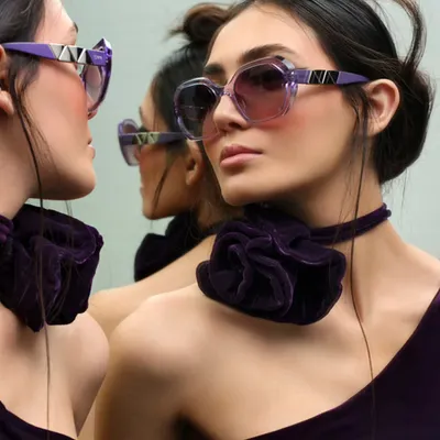 A creative eyewear shot using mirrors to create an infinite reflection. This image for IDEE Eyewear plays with perspective and symmetry, highlighting the unique design of the purple frames.