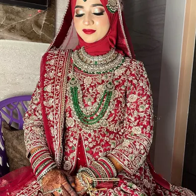 My signature bridal look for my stunning hijabi bride, Fatima. The red hijab is perfectly styled, and the makeup features a classic red lip and shimmery gold eyes.