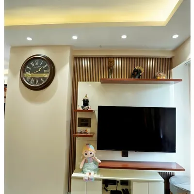 This TV unit combines floating shelves and vertical wooden slats for a clean, modern look. The design provides ample display space while maintaining a light and airy feel in the living area.