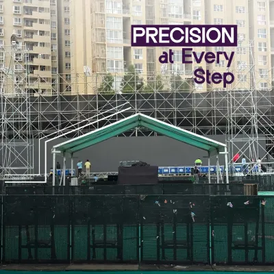 Precision at every step. This image shows the construction of a large stage, with the underlying scaffolding and barricades visible. It represents my commitment to building strong, safe, and flawless event structures.