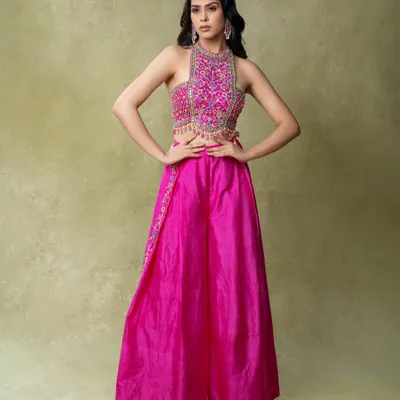 A vibrant e-commerce shot for an ethnic wear brand. The clean background and bright lighting ensure the hot pink color is accurate, while the power pose shows off the full outfit.