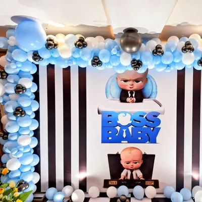 A classic Boss Baby themed birthday party. I used a black and white striped backdrop, a blue and white balloon arch, and character cutouts to bring the popular movie to life.