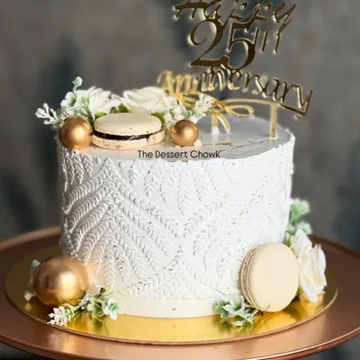 I love the texture on this tall anniversary cake, created using a stencil technique on fresh whipped cream. Paired with macarons and gold details, it creates a truly unique and elegant look.