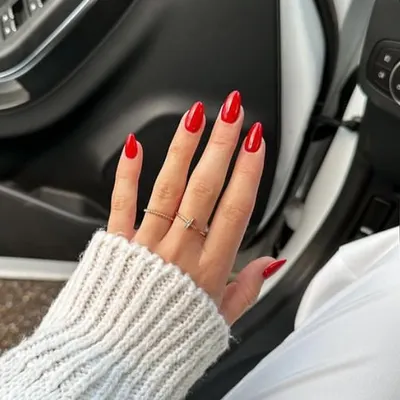 A classic, vibrant red on long almond-shaped nails. A perfect red manicure is timeless, confident, and always in style.