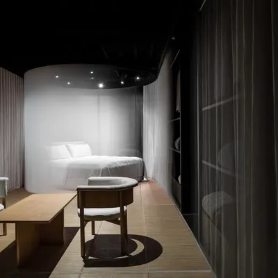 In this retail project, we used ephemeral elements like sheer, motorized curtains to create a sense of discovery. The design creates a serene, pod-like sanctuary for the display bed, separating it from the main space while maintaining a light, veiled connection that invites curiosity.