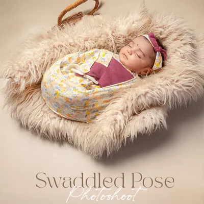 A swaddled pose photoshoot captures the peaceful, sleepy essence of a newborn. Wrapped snugly in a fluffy basket, this baby is the picture of serenity.