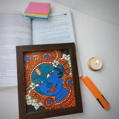 This 9x10 inch framed Narayana painting is shown on a desk, adding a touch of divinity to a workspace. It’s a perfect example of how a small piece of art can bring so much peace.