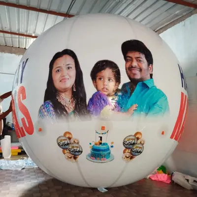 I print your favorite photos directly onto large, white, round balloons. This example shows a full-color family portrait for a first birthday celebration, demonstrating the clarity and scale of the final product. It's a great way to make personal events memorable.