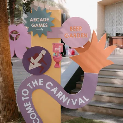 Welcome to the carnival! This fun, colorful signage directed guests to the beer garden and arcade games at a playful Mehendi celebration, setting the tone for an afternoon of fun.
