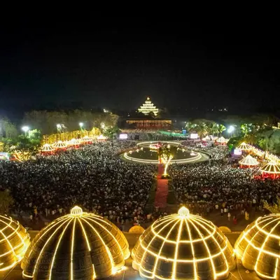 A panoramic view of the Maha Shivratri celebrations at night. The entire ashram is lit up, and the energy of thousands meditating together creates an unforgettable spiritual ambiance.