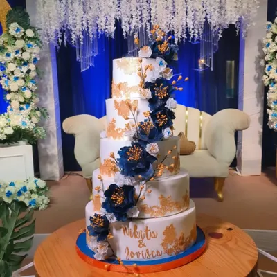 My largest wedding cake to date, this 25kg, five-tier creation featured alternating Dutch truffle and rum plum cake layers. It was adorned with beautiful navy blue wafer paper peonies and gold leaf details for a touch of luxury.