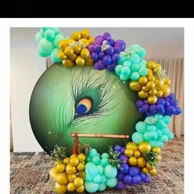 This is one of my favorite custom backdrops, created for a Krishna Janmashtami celebration. I designed and hand-painted the large peacock feather panel and added a traditional flute, framed by a beautiful balloon arrangement in gold, purple, and teal. It creates a divine and artistic centerpiece for any religious event.