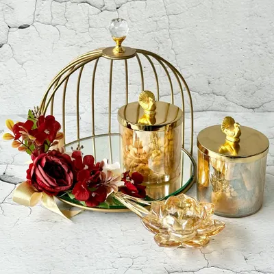 This elegant gold birdcage hamper, filled with gourmet treats and a crystal lotus diya, is a perfect example of how I blend luxury with thoughtful details. It's a statement piece, designed to make any celebration feel truly special.