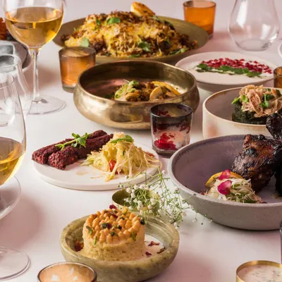 A vibrant spread showcasing the diversity of our Modern Indian menu. Dishes like beetroot kebabs, deconstructed chaat, and jackfruit biryani are presented with contemporary flair.