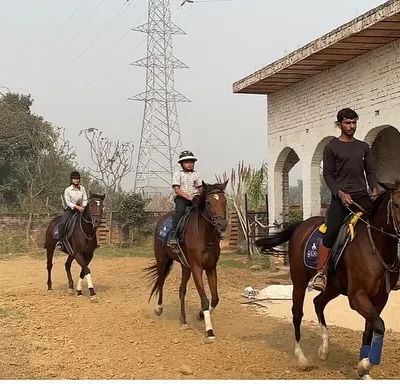 An instructor guiding riders in our open sandy arena. Our certified trainers are always on hand to provide guidance, whether you are training for competition or riding for pleasure.