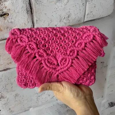 This hot pink sling bag is all about making a statement! The intricate knotting on the flap and the soft fringe make it so special. It's a clutch and a sling bag in one, perfect for adding a pop of color.