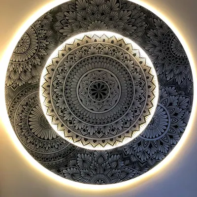 The final look of the layered and backlit mandala. The warm light creates a halo effect, highlighting the intricate details and making the artwork float off the wall.