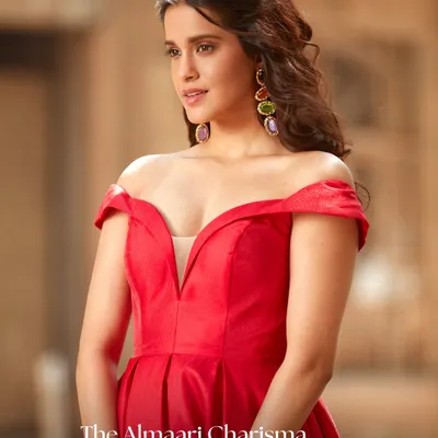 This off-the-shoulder red gown is pure glamour. The structured bodice and deep neckline are designed to make a powerful statement, perfect for any black-tie event or formal party.