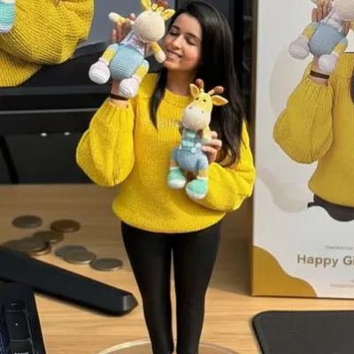 This is me, Simi, holding a miniature version of myself with our crochet giraffe. This image tells our story, a journey that began during lockdown and has now blossomed into a creative venture celebrating handmade art and supporting women artisans.