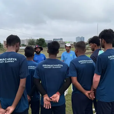 A coach's guidance is the cornerstone of a team's success. Here, our players listen intently during a strategy session, absorbing lessons on game awareness and execution that are vital for competitive cricket.