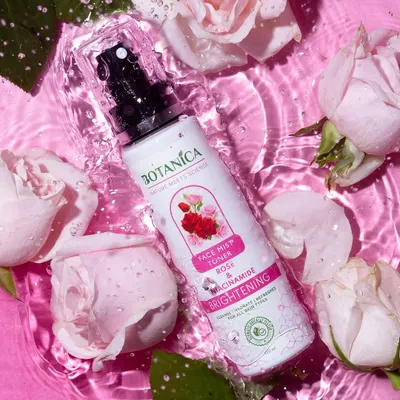 A refreshing shot of a rose face mist surrounded by real roses in rippling pink water. The frozen water droplets on the bottle add a sense of immediate hydration.