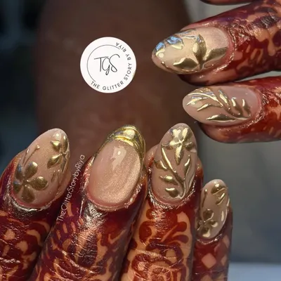 A stunning bridal set designed to complement intricate henna. These nails feature 3D gold leaf art on a neutral base, creating a look of pure opulence for the big day.