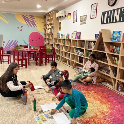 A snapshot from our Winter Camp. Children are engaged in a floor-based art activity, creating and learning in a warm and cozy environment.