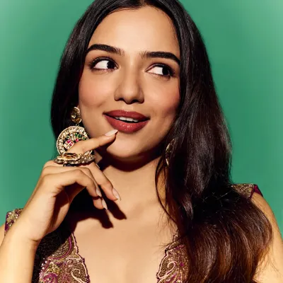 A playful and vibrant look for Ahsaas Channa. This purple and gold ensemble is paired with oversized traditional earrings, showcasing a fun approach to festive dressing.