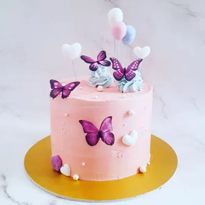 A beautiful custom cake for a baby shower with a butterfly theme. We work with talented bakers to create delicious cakes that are also a centerpiece of your decor.
