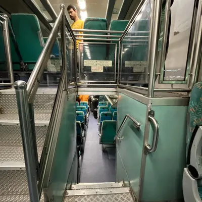 A view from the upper deck looking down the stairs to the lower deck of the Mumbai-Ahmedabad double-decker express train.