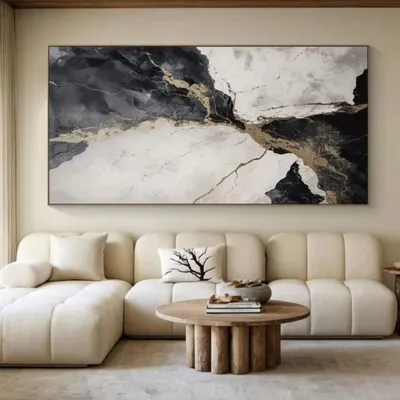 This large-scale abstract painting in black, white, and gold adds a touch of drama and luxury to a minimalist living room. We design such pieces to complement your furniture and create a cohesive, high-end look.