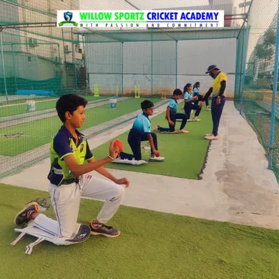 Young bowlers practicing their action while kneeling. This drill isolates the upper body, helping to perfect arm rotation and release without worrying about the run-up.
