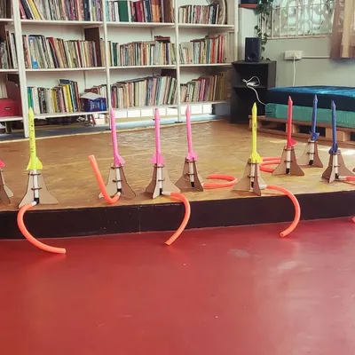 A fleet of stomp rockets, built and ready for launch! Each camper makes their own, learning about aerodynamics and pressure before the exciting outdoor launch session.