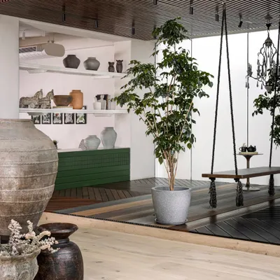 We created distinct zones to showcase different product segments. A raised platform with wooden rafters and a hanging swing creates an inviting, outdoor-inspired nook, separating the space while adding a touch of charm and encouraging exploration.