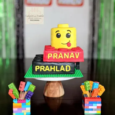 Le-go of your worries and have some cake! This fun Lego-themed cake was made for a pair of brothers, featuring edible Lego blocks and a cheerful Lego head topper.