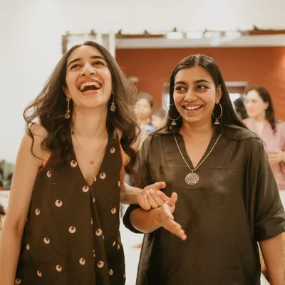 This is us, Nandini and Shivangi, sharing a laugh at an at-home mehendi. We've coined the term 'Dal Makhani Brown' for this comforting, earthy color that feels like a warm hug, perfectly reflecting our love for all things homegrown and soulful.