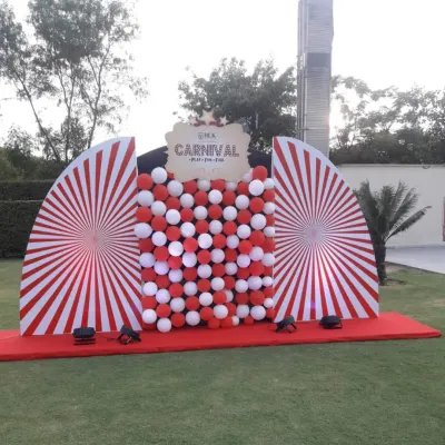 A classic red and white carnival-themed photo booth I set up for an outdoor event. The bold stripes and balloon wall create a festive backdrop for guests to capture memories.