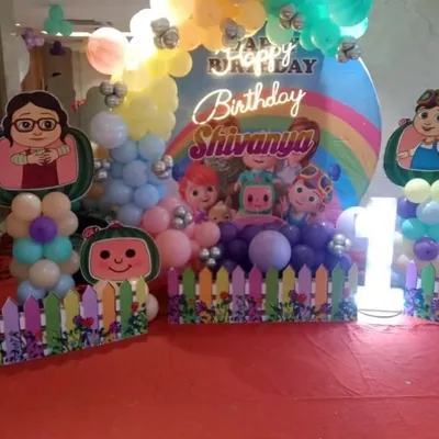 A fun and colorful Cocomelon themed birthday party setup for a child's celebration. I provide the complete decor package, including the character cutouts, balloon arrangements, and a custom backdrop with a neon birthday sign.