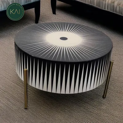 A bold, round coffee table featuring a striking black and white sunburst pattern created with bone inlay. This unique piece is a testament to our dedication to artisanal craftsmanship and creating furniture that makes a statement.