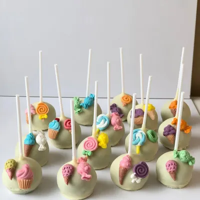 Welcome to Candyland! These fun cake pops are decorated with tiny, handcrafted candies, lollipops, and ice cream cones.
