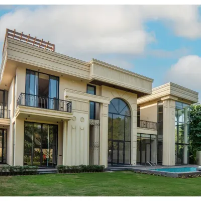 The facade of our Sultanpur farmhouse is a blend of classical charm and modern sophistication. I used grand arches and decorative columns to create a sense of symmetry and timeless appeal, while the double-height glass floods the interiors with natural light.