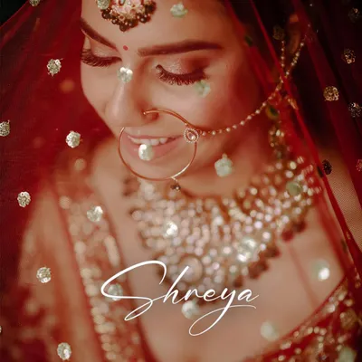 A beautiful close-up of the bride, with a soft, dreamy effect. This portrait captures her happy smile and the intricate details of her nath and jewelry, making it a timeless keepsake.